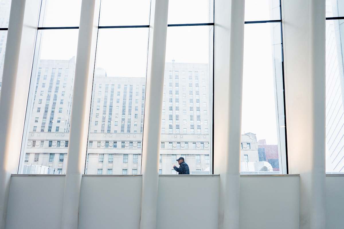 human man standing near glass wall person